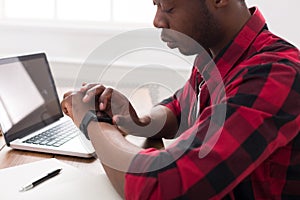 Black businessman in casual office, work with laptop