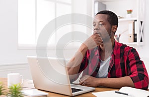 Black businessman in casual office, work with laptop