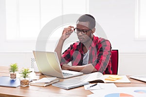 Black businessman in casual office, work with laptop