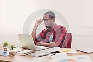 Black businessman in casual office, work with laptop