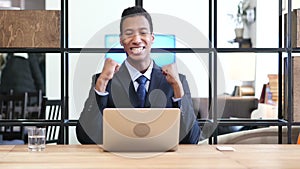 Black Businessman Celebrating Success, Working on Laptop