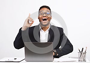 Black Businessman At Laptop Having Idea Sitting Over White Background
