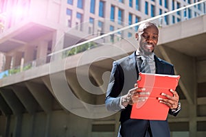 black businessman looking at his tablet computer in urban background02 photo