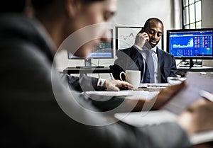 Black businessman making a call in business meeting