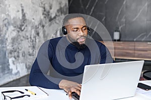 Black businessman making video conference on laptop sitting at home