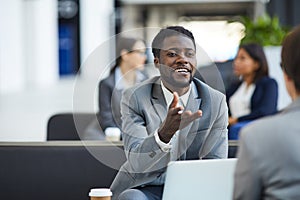 Black businessman meeting with partner in lobby