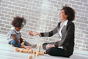 Black businessman mother playing with her children together in the house learning concept