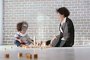 Black businessman mother playing with her children together in the house learning concept