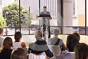 Black businessman presenting business seminar to an audience