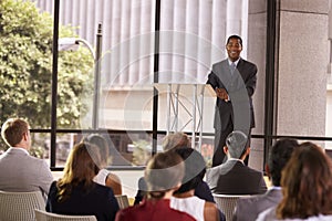 Black businessman presenting seminar smiling to audience