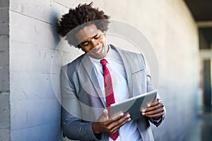 Black Businessman using a digital tablet in urban background photo