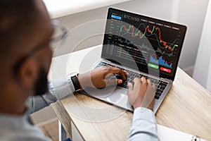 Black Businessman Using Laptop, Trading Online, High-Angle View