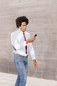 Black Businessman using a smartphone near an office building photo