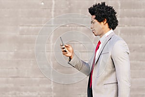 Black Businessman using a smartphone near an office building photo