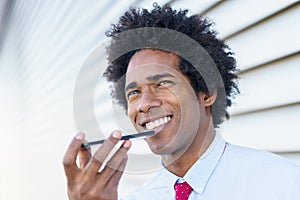 Black Businessman using a smartphone near an office building photo