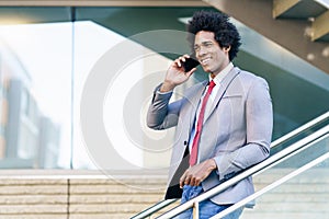 Black Businessman using a smartphone near an office building photo