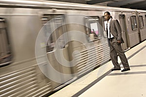 Black Businessman Watching the Metro Train Pass