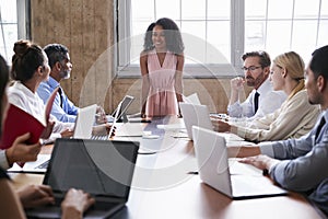 Black businesswoman addressing colleagues at a board meeting