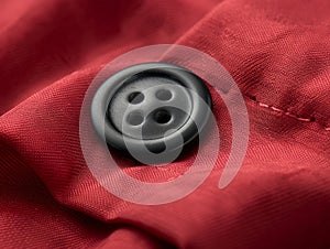 black button on red textile