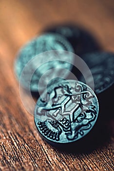 Black buttons on wooden background