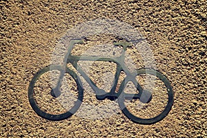 Black bycicle sign on lanes asphalt road.