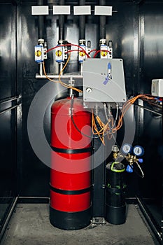 Black cabinet with modern industrial automatic fire extinguishing unit