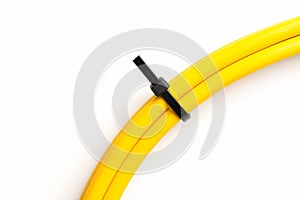 Black cable ties on yellow cable isolated on white background. object picture for graphic designer