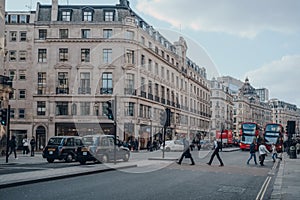 Black cabs, buses and people on Regent Street, London, UK