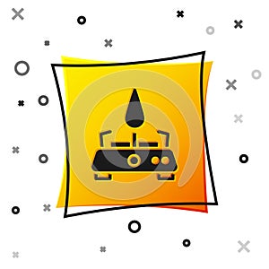 Black Camping gas stove icon isolated on white background. Portable gas burner. Hiking, camping equipment. Yellow square