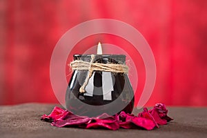 Black candle cup on red background