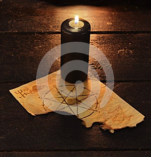 Black candle with pentacle