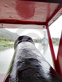 Black cannon of black boat with red in park jaime duque