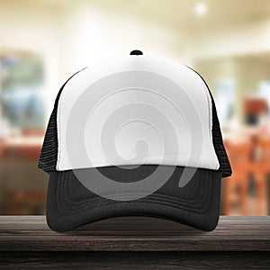 Black cap made from fabric material on dressing room background with mockup baseball caps style. White caps template place on