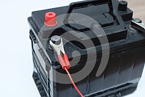 Black car accumulator battery on a white background. Acid battery,12 volts supply. Concept of service, maintenance, charging car