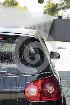 Black car being washed at a car wash