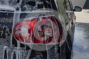 Black car being washed at a car wash