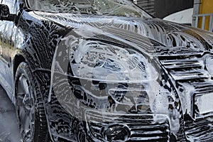 Black car being washed at a car wash