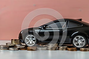 black car with coins, car tax and financing, car insurance and car loans, concept of saving money on buying a car at a