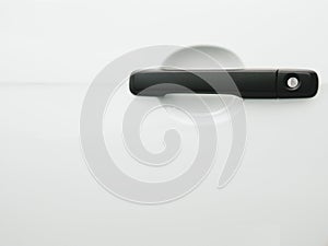 Black car door handle on white background. Automobile and texture concept. Automotive industry and safety lock and remote key