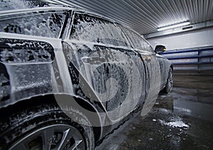 Black car in foam on sink