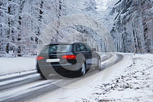 Black car in a frozen winter forest