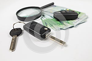 Black car key euro money on white. Auto insurance