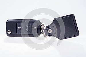 Black car key with remote central locking and pendant