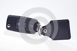 Black car key with remote central locking and pendant