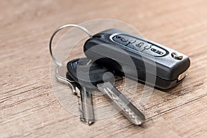 Black car key on wooden desk