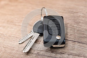 black car key on wooden desk