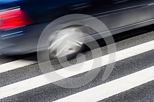 Black car with motion blur on street