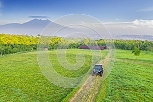 Black car moving on hills with misty mountain view