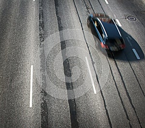 Black car moving on old highway road