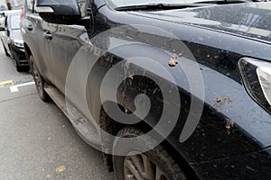 Black car in mud stains.
